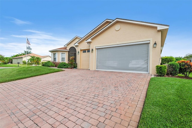 single story home featuring a garage and a front yard