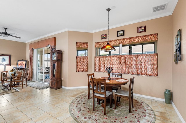 tiled dining area featuring ceiling fan and ornamental molding