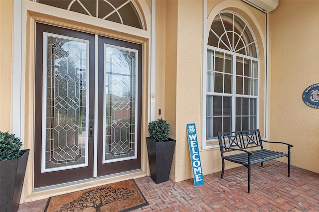 4496 Strathmore Dr, Lake Wales, FL 33859 - doorway to property with stucco siding and covered porch