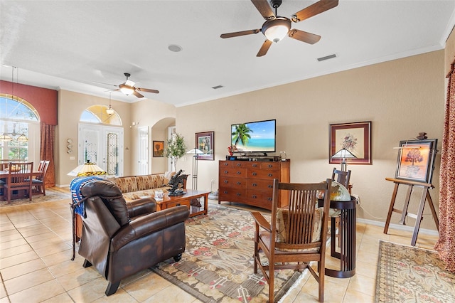 tiled living room featuring ornamental molding and ceiling fan