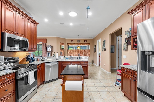 kitchen with pendant lighting, ornamental molding, a center island, light tile patterned floors, and stainless steel appliances