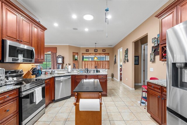 4496 Strathmore Dr, Lake Wales, FL 33859 - kitchen featuring appliances with stainless steel finishes, a peninsula, crown molding, a sink, and a kitchen island