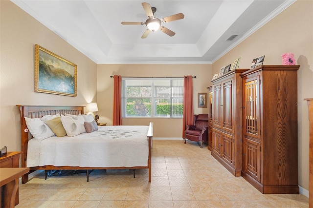 bedroom featuring ceiling fan, ornamental molding, and a tray ceiling