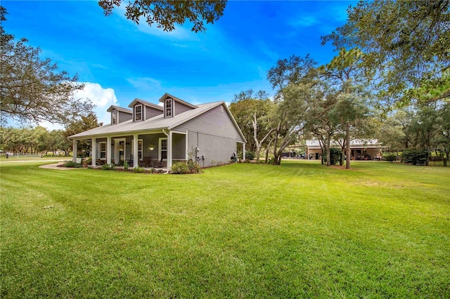 view of property exterior with covered porch and a yard