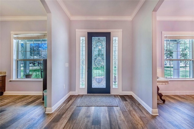 entrance foyer with baseboards, arched walkways, dark wood-style flooring, and ornamental molding