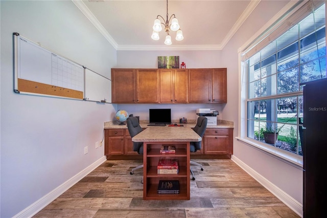 home office with built in desk, a notable chandelier, crown molding, and hardwood / wood-style floors