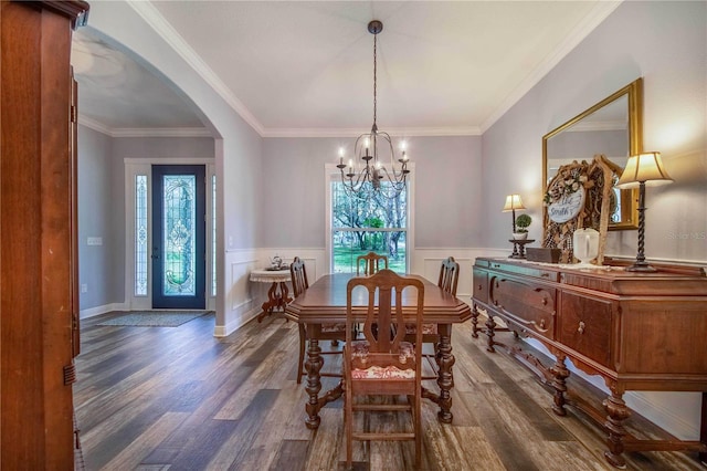 dining room with a notable chandelier, dark hardwood / wood-style flooring, and crown molding