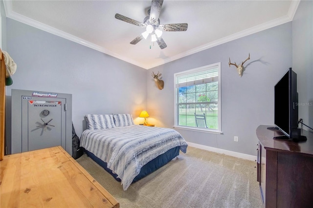 carpeted bedroom with ornamental molding and ceiling fan