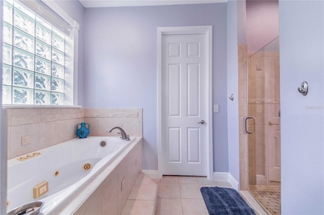 full bathroom featuring tile patterned flooring, baseboards, a shower stall, and a tub with jets