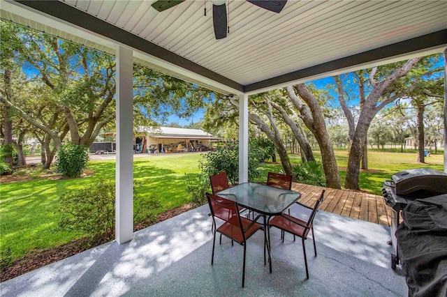 view of patio with outdoor dining area, a grill, and ceiling fan