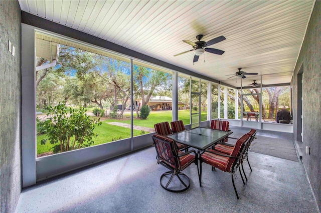 sunroom / solarium featuring ceiling fan