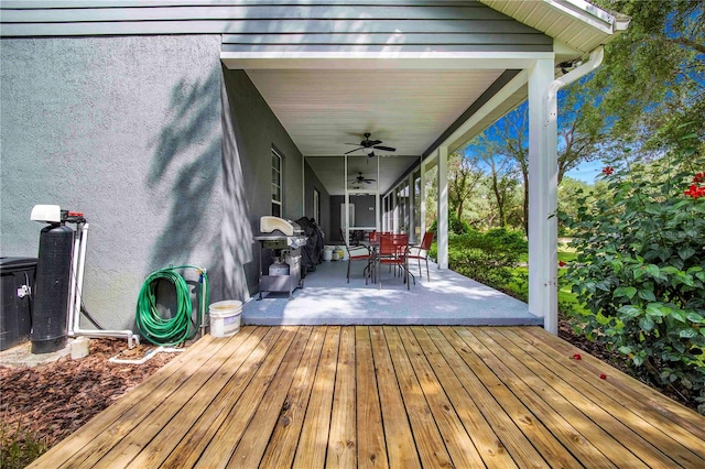 wooden deck featuring grilling area and ceiling fan