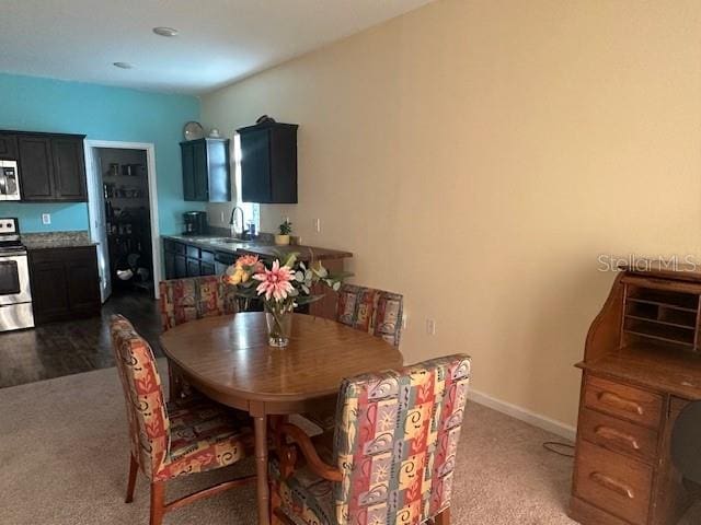 dining area with carpet floors and baseboards