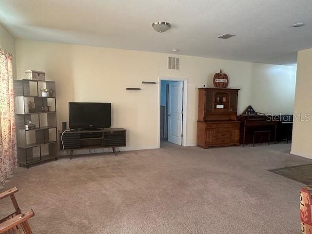 living room featuring visible vents and carpet flooring