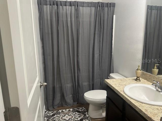 full bath featuring toilet and vanity