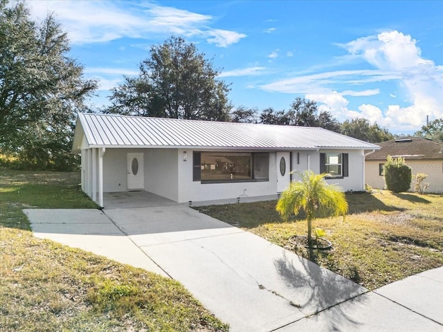 ranch-style house featuring a carport and a front yard