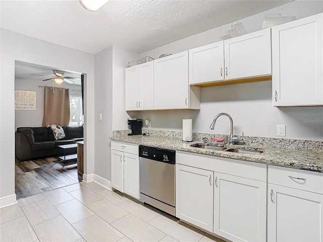 kitchen with sink, a textured ceiling, dishwasher, light stone countertops, and white cabinets