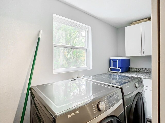 laundry area with cabinets and independent washer and dryer