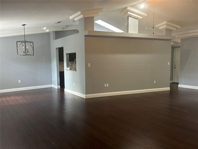 interior space featuring dark hardwood / wood-style flooring, high vaulted ceiling, and a chandelier