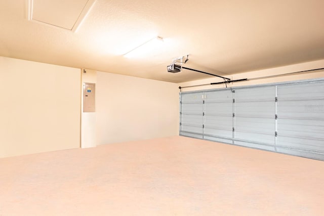 garage with electric panel and a garage door opener