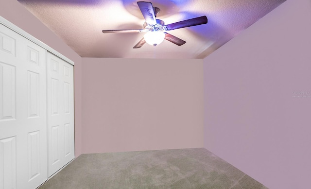 unfurnished bedroom featuring a textured ceiling, carpet, ceiling fan, and a closet