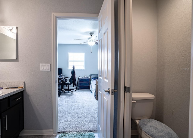 bathroom featuring vanity, ceiling fan, and toilet