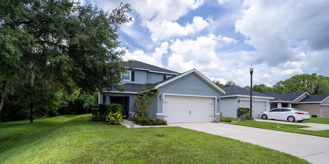 view of front of property with a garage and a front lawn