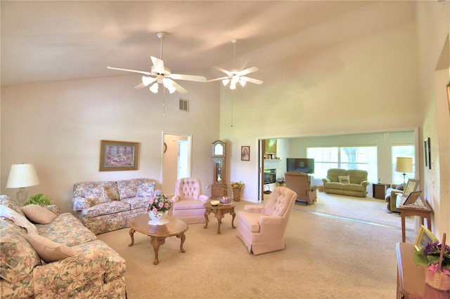 living room featuring light carpet, high vaulted ceiling, and ceiling fan