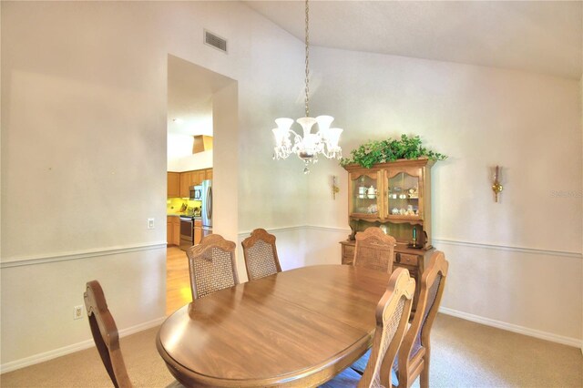 dining room with a chandelier and light colored carpet