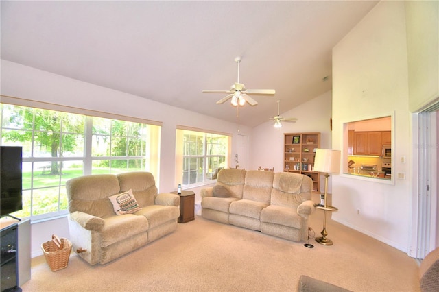 carpeted living room with ceiling fan, high vaulted ceiling, and a wealth of natural light