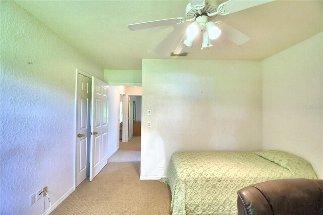 bedroom featuring ceiling fan and light carpet