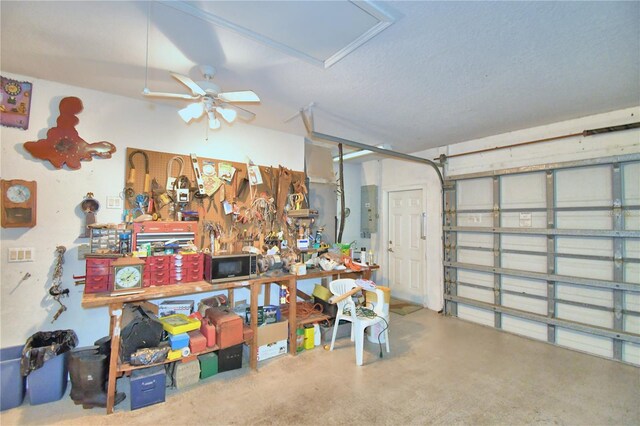 garage featuring ceiling fan and a workshop area