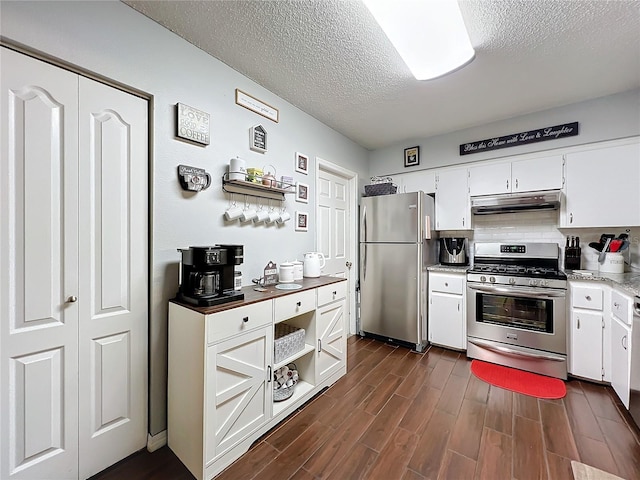 kitchen with white cabinetry, stainless steel appliances, and a textured ceiling