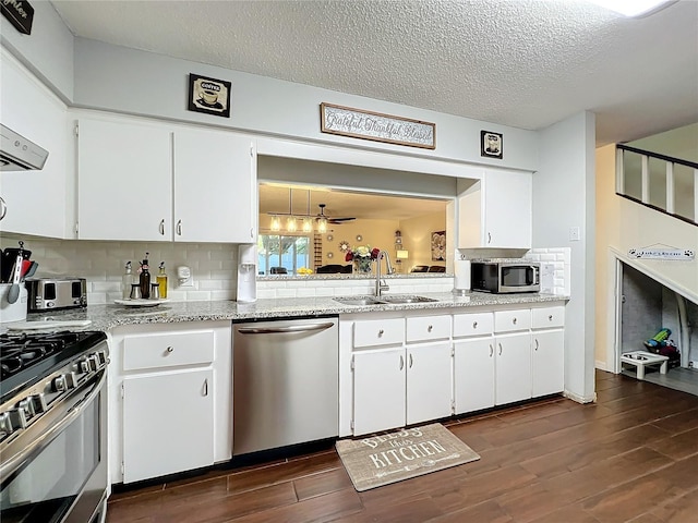 kitchen with ceiling fan, sink, white cabinetry, and stainless steel appliances