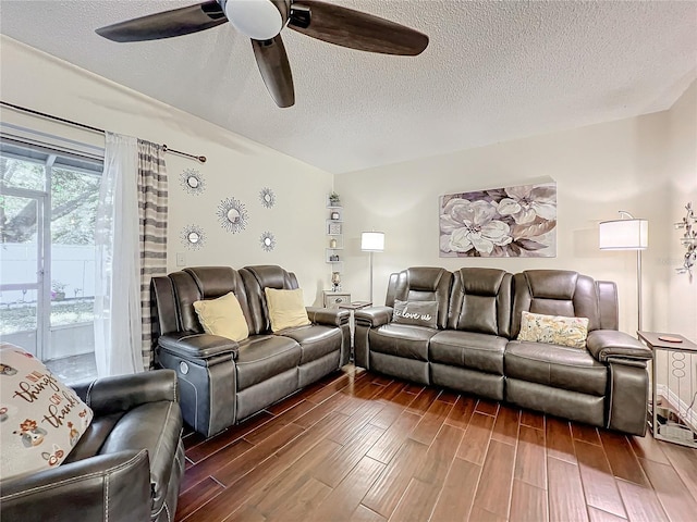 living room featuring a textured ceiling and ceiling fan