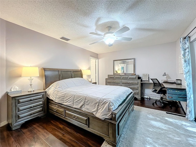 bedroom featuring a textured ceiling, ceiling fan, and dark wood-type flooring