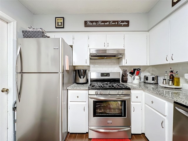 kitchen featuring decorative backsplash, stainless steel appliances, white cabinetry, and light stone counters