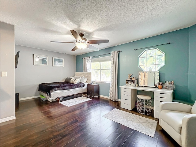 bedroom featuring a textured ceiling, dark hardwood / wood-style flooring, and ceiling fan