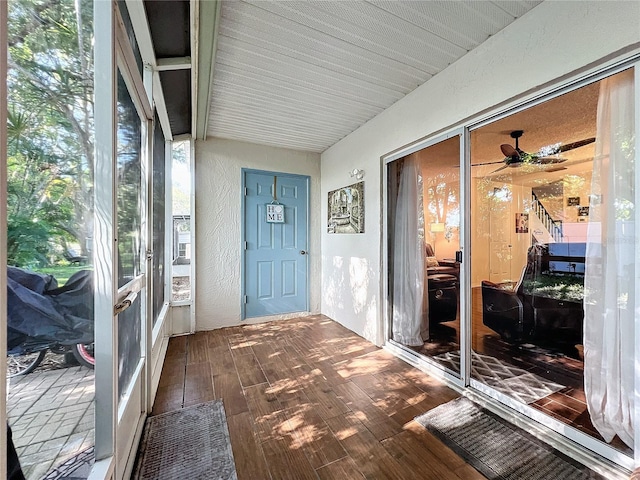 sunroom / solarium featuring ceiling fan