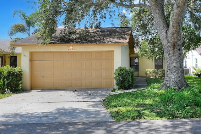 view of front of property with a garage, concrete driveway, and stucco siding