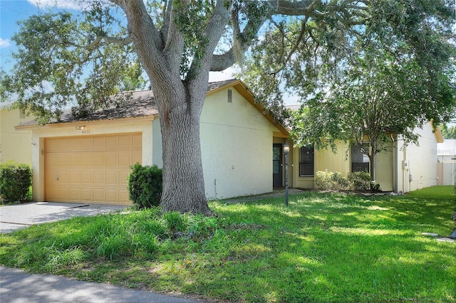 view of front of home featuring driveway, a front lawn, and stucco siding