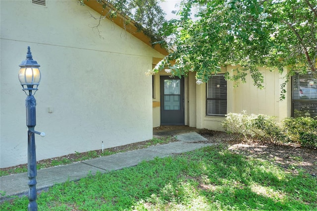 property entrance with stucco siding