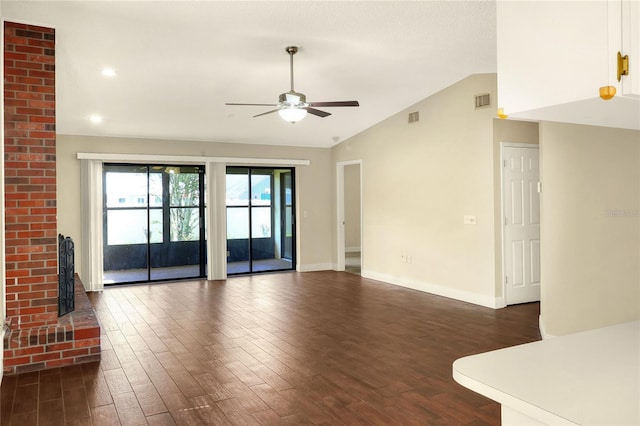 unfurnished living room featuring lofted ceiling, a fireplace, dark wood-style floors, and visible vents