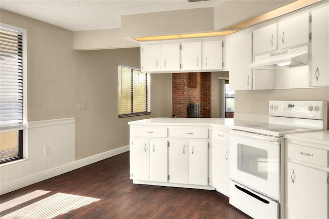 kitchen featuring a peninsula, light countertops, white electric range, under cabinet range hood, and white cabinetry