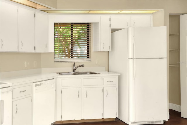 kitchen with light countertops, white appliances, a sink, and white cabinets