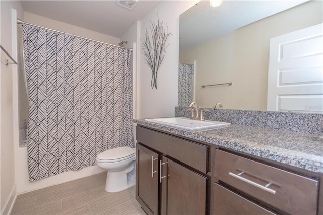 full bathroom featuring shower / bath combo, tile patterned floors, vanity, and toilet