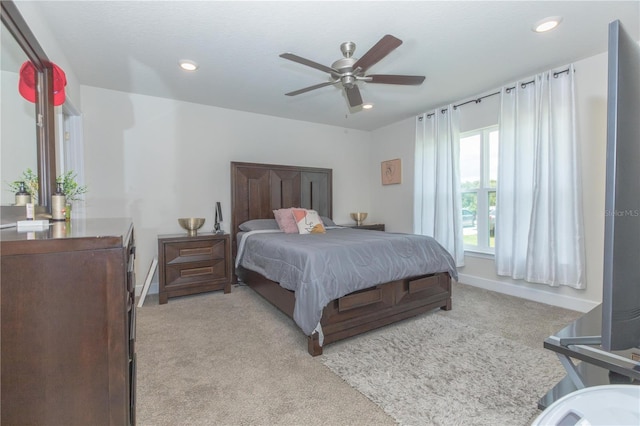 bedroom with ceiling fan and light colored carpet