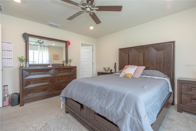 bedroom featuring ceiling fan and light carpet