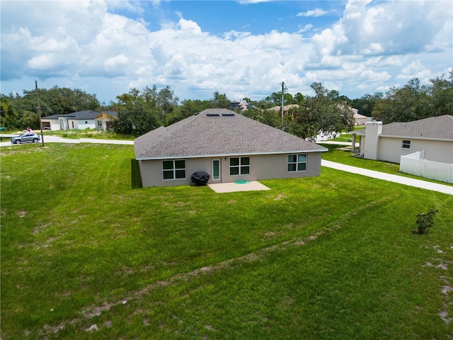 back of property featuring a yard