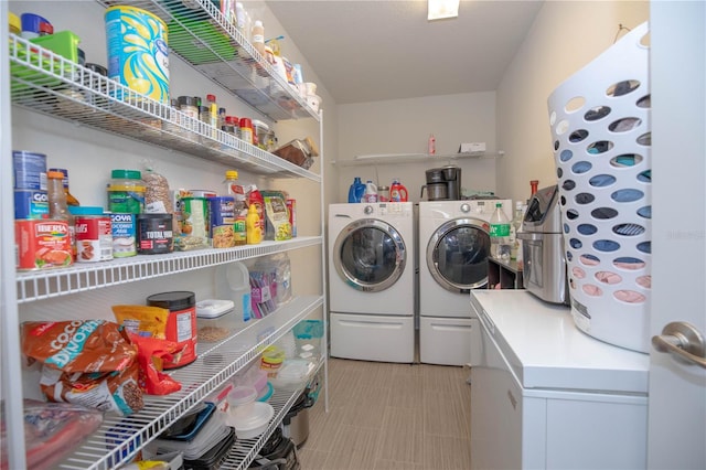 laundry area featuring washing machine and clothes dryer and light tile patterned floors